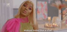 a woman says mabusi looks like a vibe while wearing a pink and green dress