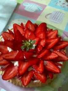 a pie with strawberries and cream on a table