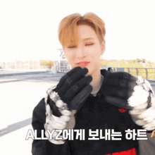 a man wearing gloves with the word allyz written on the bottom