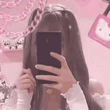 a girl is taking a picture of herself in a mirror .