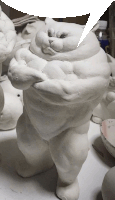 a statue of a fat cat with a speech bubble behind it