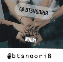 a group of people putting their hands together with a sticker that says @ btsnoori8 on it