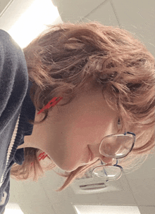 a close up of a person wearing glasses and earbuds