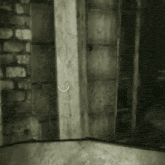 a black and white photo of a brick wall with a smiley face on it