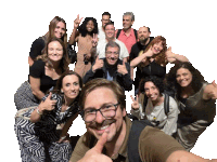 a group of people posing for a picture with one man giving the thumbs up