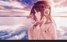 a girl wearing headphones looks out over the water