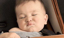 a baby is making a funny face while laying in a crib