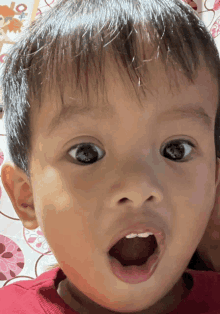 a close up of a child 's face with his mouth wide open