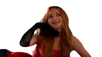 a woman in a red dress is making a heart shape with her hand