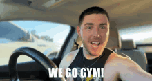 a man in a car with the words " we go gym " written on his face