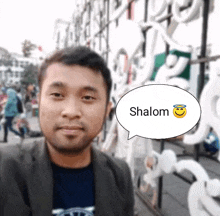 a man with a speech bubble with the word shalom on it