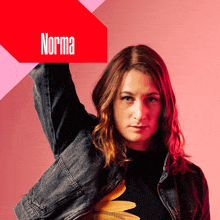 a woman in a denim jacket stands in front of a sign that says norma