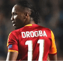 a soccer player named drogba is wearing a red jersey with the number 11 on it