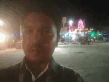 a man is taking a picture of himself in front of a temple at night