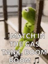 kermit the frog is sitting on a railing and says `` match in the gas tank boom boom '' .
