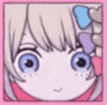 a close up of a girl 's face with big blue eyes and hearts on her hair .