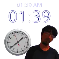 a man stands in front of a wall clock that says 1:39 am