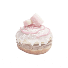 a donut with white frosting and pink and white sprinkles on top