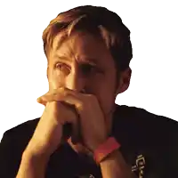 a man covering his mouth with his hands while wearing a black shirt that says ' i 'm sorry '