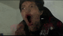 a pixelated image of a person with their mouth open .