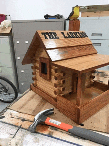 a wooden birdhouse with the name the larkins on the roof