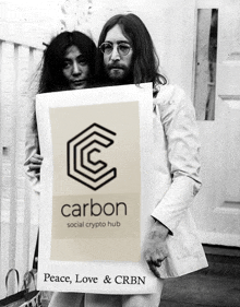 a man and a woman hold a sign that says carbon social crypto hub