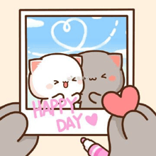 a person is holding a picture of two cats holding a heart .