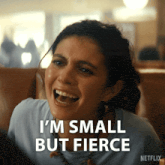 a woman is laughing with the words i 'm small but fierce behind her