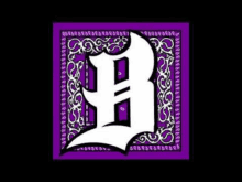 a purple bandana with a white letter b on it .