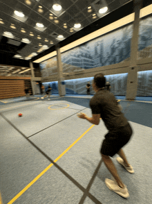 a group of people are playing a game of basketball in a gym