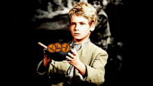 a young boy is holding a bowl with three coins in it and one of them says truth