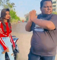 a man and a woman are standing next to each other .