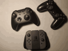 a nintendo switch controller sits next to a xbox controller and a ps4 controller