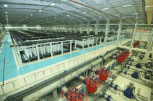 a large warehouse filled with lots of pipes and pumps including one that says ' a ' on it