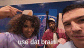 a man and a woman are posing for a picture and the man is pointing at the woman 's hair .
