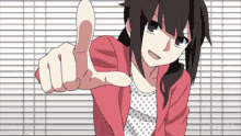 a girl in a red jacket is giving a thumbs up sign