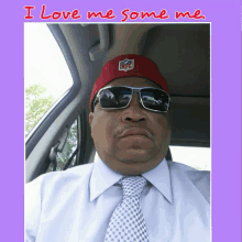 a man wearing a red nfl hat and sunglasses is sitting in a car