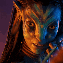 a close up of a person 's face with a blue and green face paint