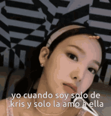 a close up of a woman 's face with the words yo cuando soy solo de kris and solo la amo a ella