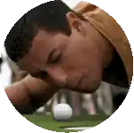 a man is looking down at a golf ball on a green