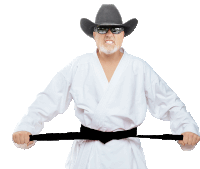 a man wearing a cowboy hat and sunglasses is holding a black belt around his waist