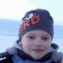 a young boy wearing a hat that says bird