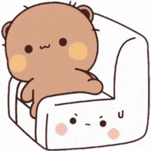 a teddy bear is sitting on a white couch .