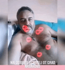 a shirtless man is laying on a bed with red kisses on his face .