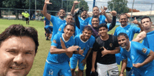 a group of soccer players are posing for a picture and one of them has the number 14 on his shirt