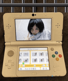 a nintendo 3ds displays a picture of a girl on the screen