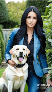 a woman in a denim jacket holds a dog in her lap