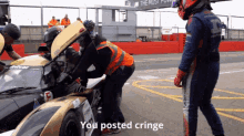 a man in a helmet stands next to a race car with the words " you posted cringe " on the bottom