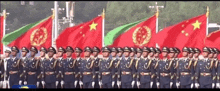 a group of soldiers marching in a line with their flags