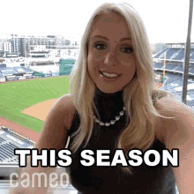 a woman says this season cameo in front of a baseball field ..